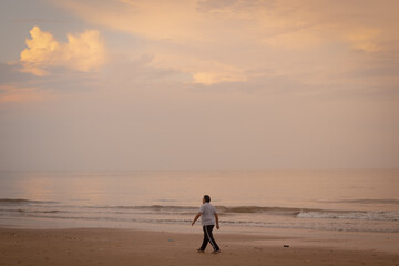 Fototapeta na wymiar person walking on the beach
