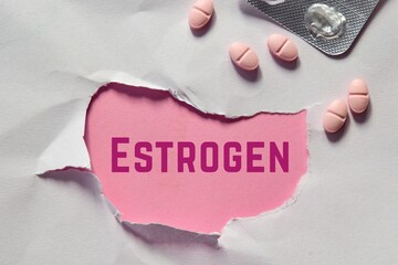 Torn paper hole with the inscription ESTROGEN and pills. Hormonal imbalance, women's reproductive health issues concept. - obrazy, fototapety, plakaty