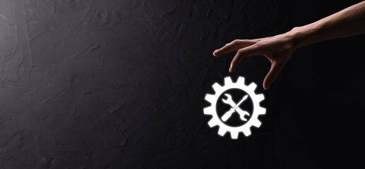 Businessman holding gear icon with tools.Gearing.Concept of target focus digital diagram,graph...