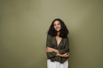 Young south asian woman with bindi smiling while looking at camera