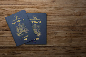 grenada passport on wooden background citizenship by investment - obrazy, fototapety, plakaty