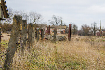 old concrete fence in the field behind the farm