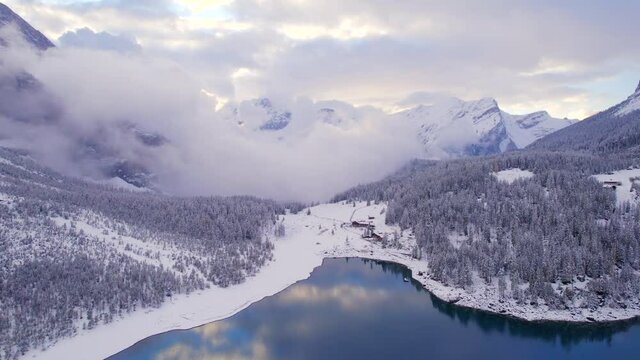 Oeschinen Lake in Switzerland Surrounded by Snow Covered Forests and Mountains