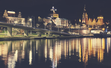 Fototapeta na wymiar Szczecin waterfront with Chrobry Embankment at night, color toning applied, Poland.