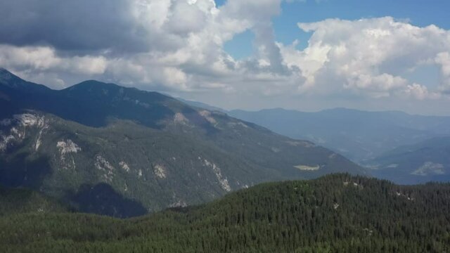 Aerial view mountain landscape of the alps. Mountain ranges with tales and cliffs peaks and forests growing on the slopes.
