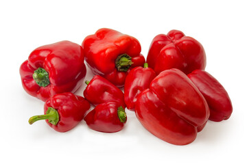 Heap of red bell peppers different size on white background
