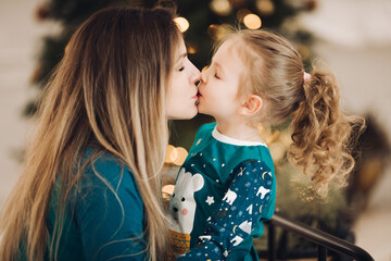 Loving mother showing affection to her cute daughter