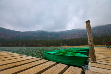 St. Ana's lake, Transylvania, Romania. Stunning autumn scenery with colorful forest and idyllic...