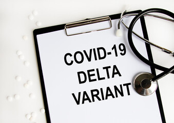The tablet has the text COVID-19 DELTA VARIANT, a number of white tablets and a stethoscope.