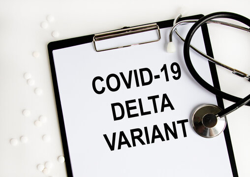 The tablet has the text COVID-19 DELTA VARIANT, a number of white tablets and a stethoscope.
