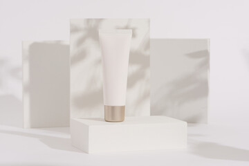 blank tube of cream skincare or cosmetic product against a minimalist white background with shadow detail