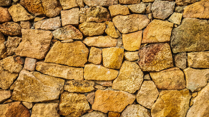 close up of wall of natural sand stones