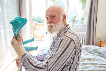 Senior mit Handgelenksbruch und Gehhilfe in Klinik