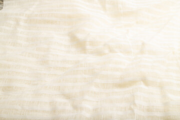 Fragment of smooth white linen tissue. Side view, natural textile background.