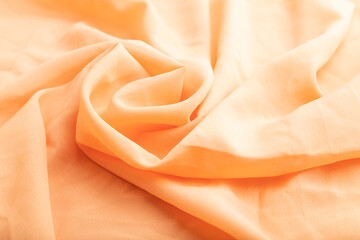 Fragment of orange linen tissue. Side view, natural textile background.
