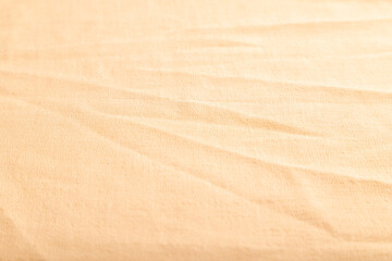 Fototapeta na wymiar Fragment of smooth orange linen tissue. Side view, natural textile background.