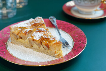 A slice of homemade apple pie on an elegant plate.