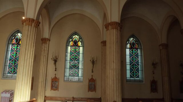 The interior of the catholic christian church in the morning sunshine.