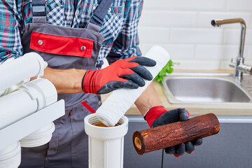 Plumber installs or change water filter. Replacement aqua filter. Repairman installing water filter...