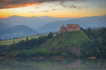 Fototapeta na wymiar Medieval Czorsztyn Castle with a reflection in the lake at sunrise. Poland