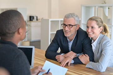 couple signing contract with real estate agent