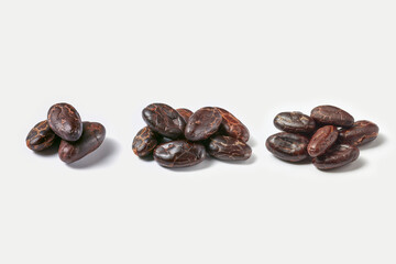 Fototapeta na wymiar Few piles of raw organic cacao beans