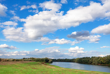 Low clouds over the river . Spring riverside scenery 