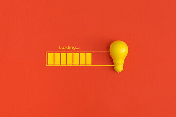 Light bulb and loading on red background. Inspiration and creative idea concept.