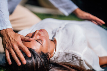 Obraz na płótnie Canvas Close-up of a Relaxed Woman Having Reiki Healing Treatment