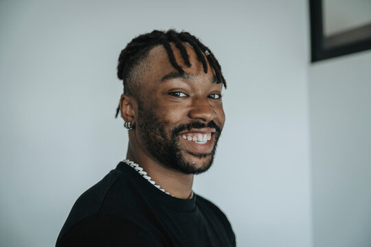 Smiling man with locs hairstyle