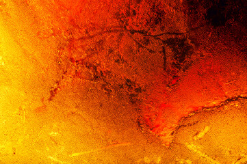 Amber macro abstract background texture, with inclusion detail, colorful yellow orange and red. unpolished rough raw specimen close-up