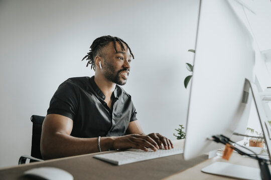 Young businessman using computer at workplace