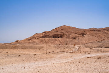 View of a small mountain with several excavations where you can see caves and ancestral tombs. Photograph taken in Luxor, Egypt. 