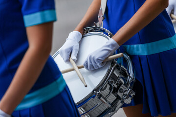 Fototapeta na wymiar Close-up. The girl drummer holds drumsticks in her hands.