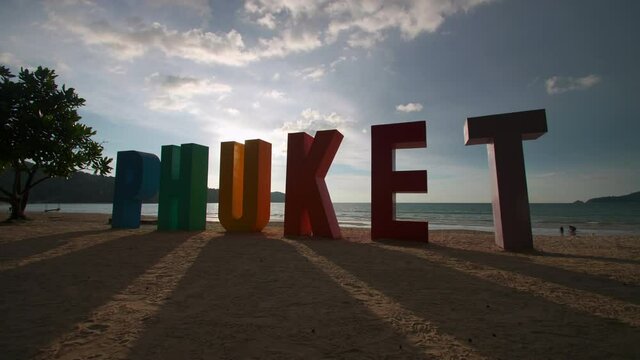 Phuket sign multi color on beach at Patong beach , Phuket Thailand. The beach with PHUKET sign and tourists on the beach