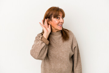 Middle age caucasian woman isolated on white background trying to listening a gossip.
