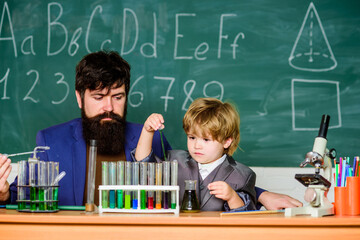 laboratory research and development. Chemistry beaker experiment. bearded man teacher with little boy. father and son child at school. Laboratory test tubes and flasks with colored liquid