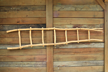 Wooden ladder in front of wooden wall