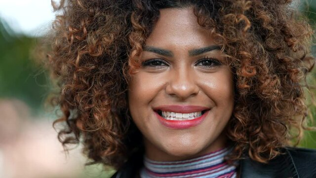 Happy Brazilian woman smiling at camera close-up face, diverse person