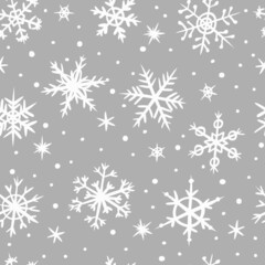 Seamless pattern of hand-drawn snowflakes on a gray background. Snowfall in doodle style. Vector illustration. Pattern for winter and Christmas design.