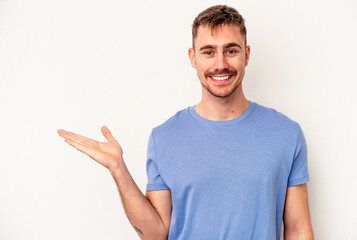 Young caucasian man isolated on pink background pointing to the side