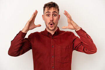 Young caucasian man isolated on white background upset screaming with tense hands.