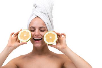 middle-aged woman after a shower wants to hold a cut orange in her hands with a smile, skin care SPA Concept