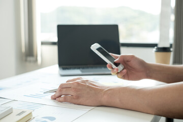 work from home, The hand of a man who works in finance sits at his desk at home and calculates financial graphs showing the results of his investments, planning the steps of his business growth