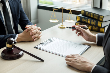 Male lawyers or a judge counseling clients about judicial justice and prosecution with scales,...