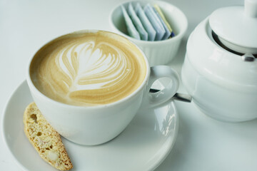a cup of late coffee with flower shape design on top at cafe 
