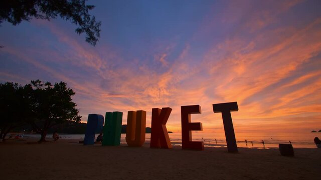 Phuket sign multi color on beach at Patong beach , Phuket Thailand. The beach with PHUKET sign and tourists on the beach