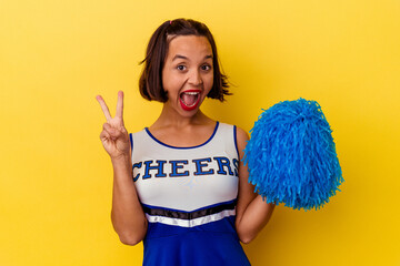 Young cheerleader mixed race woman isolated on yellow background showing number two with fingers.