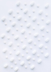 White pills on a white background. Oblong and round pills close-up. Healthcare and medicine.	
