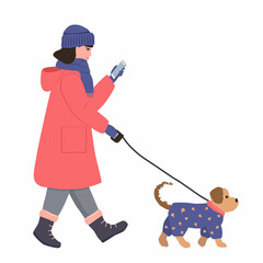 A girl in a warm coat, hat and gloves walks with a dog and looks at the phone. A small dog in a blue jumpsuit walks alongside on a leash. Illustration in flat style on white background.